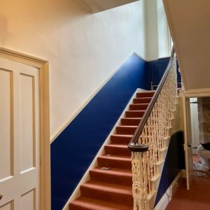 staircase with half of the wall leading up painted blue