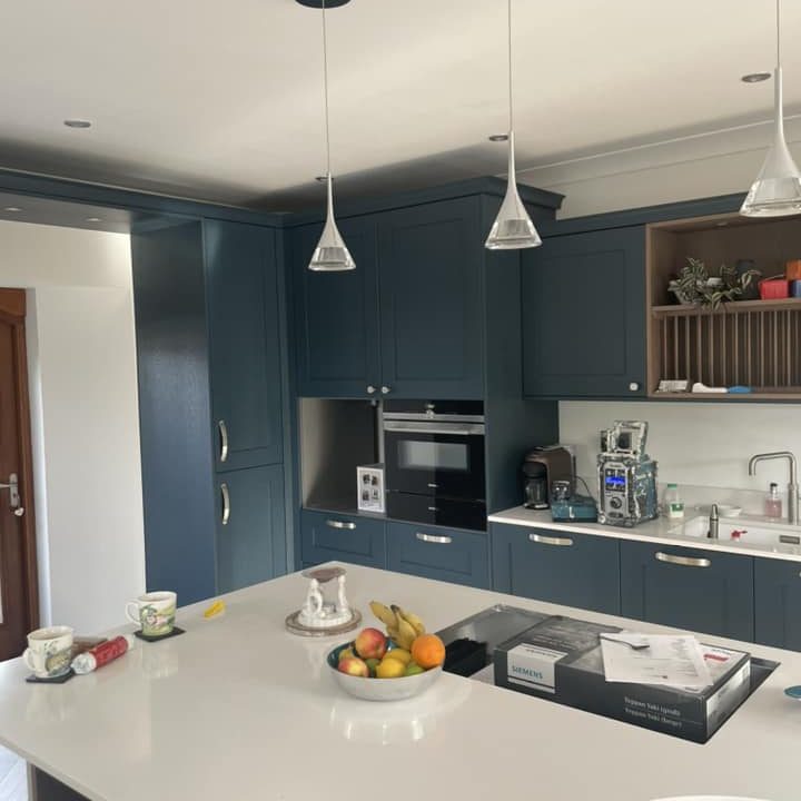 A newly painted and decorated kitchen area, coloured dark blue